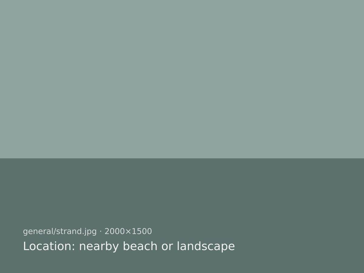 Lackan Strand at low tide with wide wet sand and low hills behind